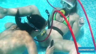Underwater lesbians lick and suck dildos